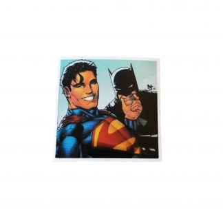 A sticker of Superman smiling while holding Batman by the Chin